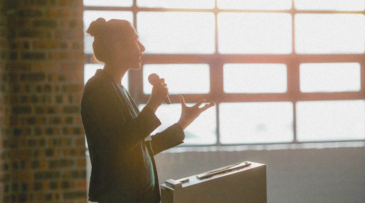 Woman speaking into a microphone