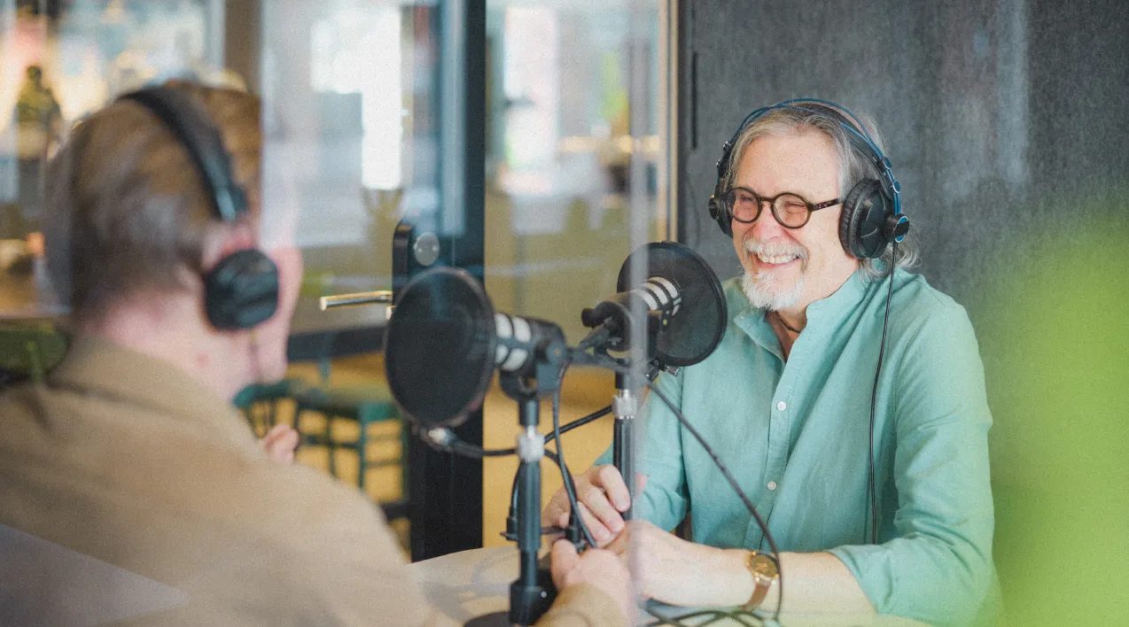 Two podcasters smiling