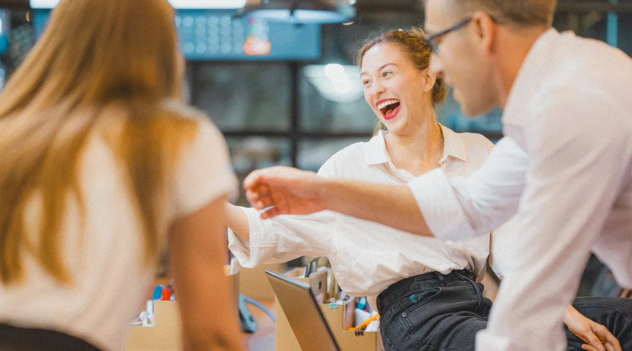 Workers smiling while collaborating