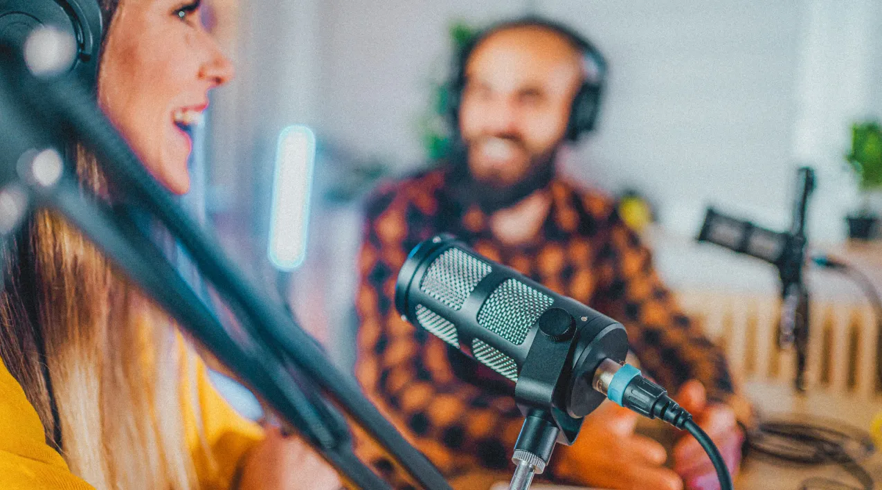 Two people talking into mics