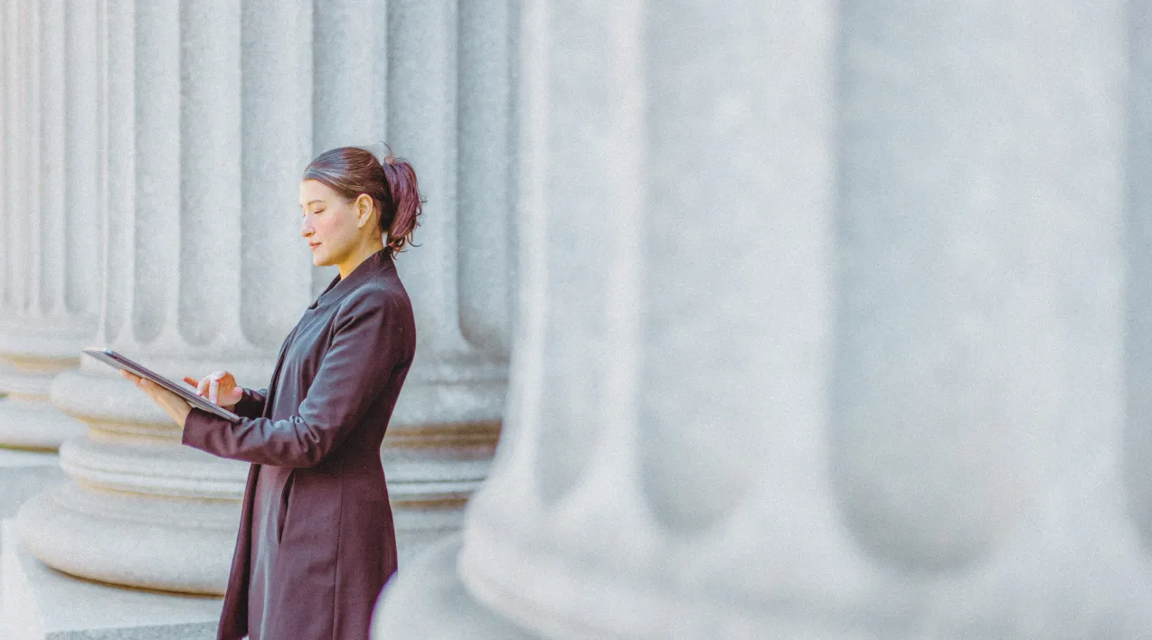 Woman standing in front of a government building