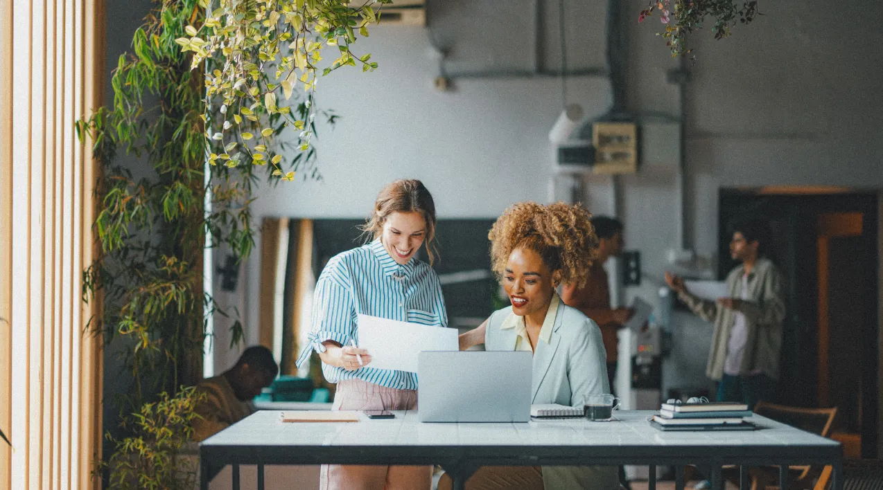 Two young businesswomen looking at a document