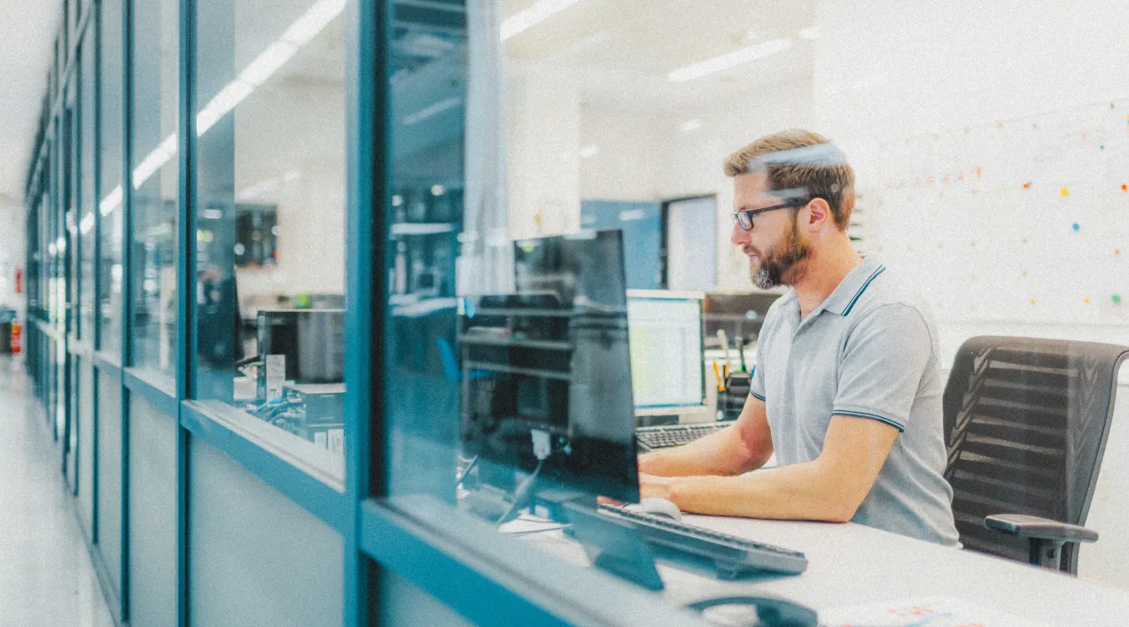 Man with glasses working on computer