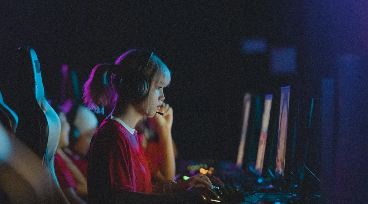 Woman with headset at a desktop computer