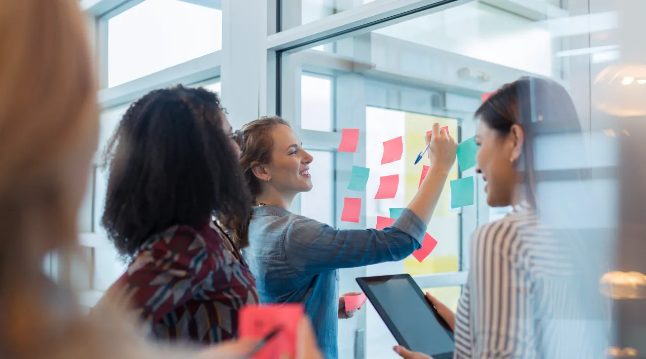 A team sticks notes to a board.