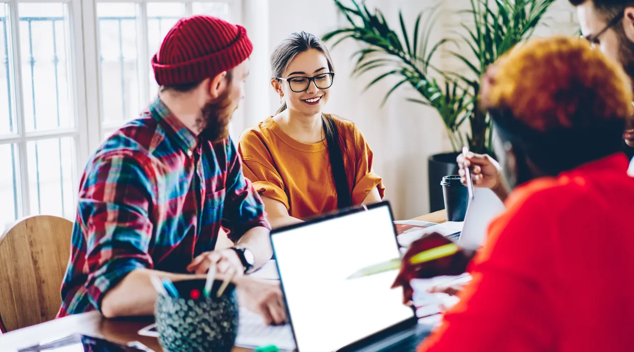 A team sits around a conference table in discussion