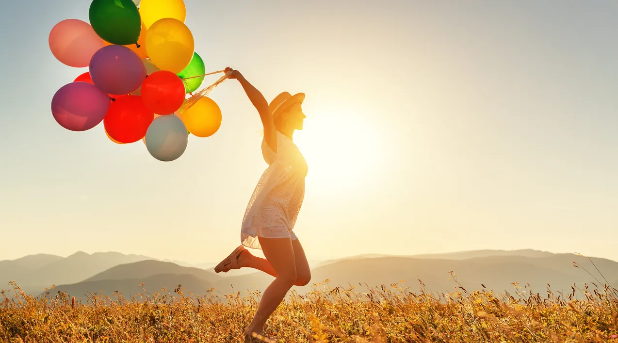 Woman running with balloons